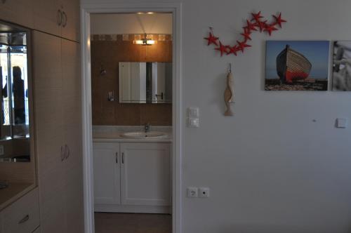a bathroom with a sink and a mirror at Poli Home in Stavros