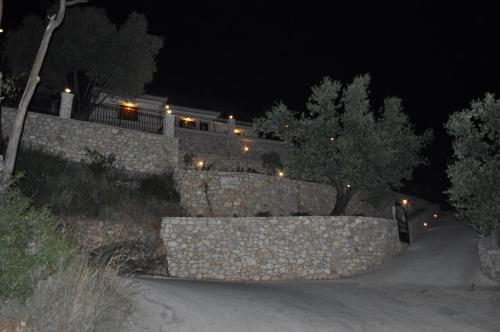 a stone wall in front of a house at night at Poli Home in Stavros