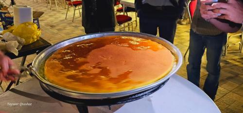 a pot of food sitting on top of a table at Al Namteh Lodge in ‘Ābil