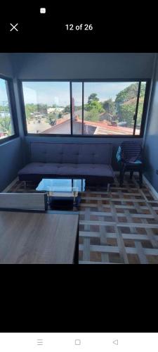 a living room with a couch and a table at Private house/room in Dauis