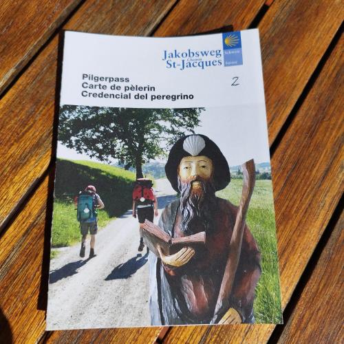 a book with a painting of a man walking down a road at Chalet La Bachole in Charancieu