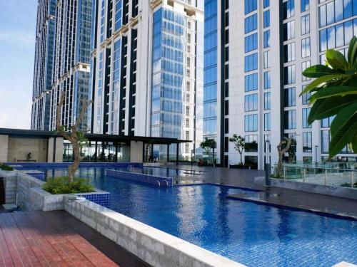 a large swimming pool in a city with tall buildings at Amazing view 2 bedrooms new apartment in Batam Center