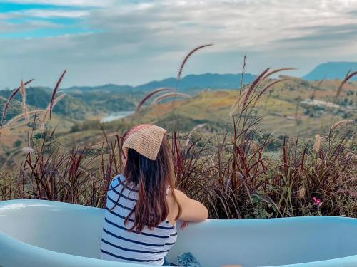 a girl sitting in a boat looking at the mountains at Papa Garden Khaokho in Khao Kho