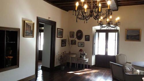 a living room with a chandelier and a table at Hotel Rural Palacio de Galceran in Sotiello