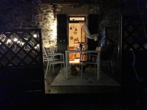 a room with a table and a dog sitting at a table at Mes Maisons Gardoises, Two Gites sleeping 13 with Two Private pools, Kids Room, Laundry, Disco, free WiFi, Linen and Dog's are Welcome in Gagnières