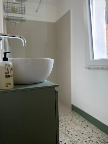 a bathroom with a sink and a bowl on a counter at La Petite Fenêtre in Casale Marittimo