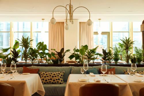 a restaurant with two tables and a couch at Crowne Plaza Belgrade by IHG in Belgrade