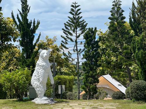 a statue of a polar bear standing in a park at Papa Garden Khaokho in Khao Kho