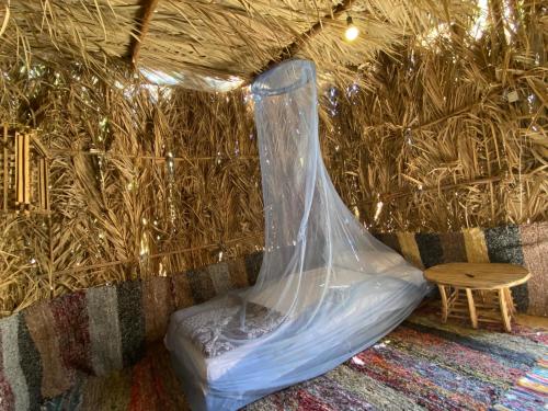 a plastic bag on a bed in a room with a table at Maya Corner in Siwa