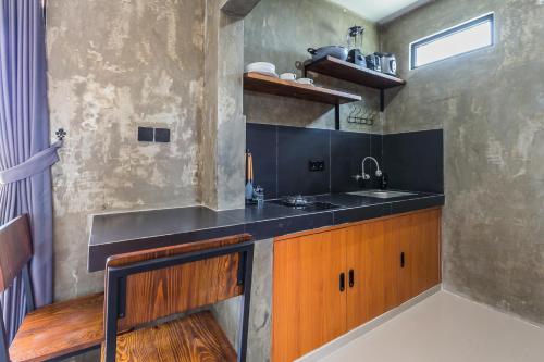 a kitchen with a sink and a counter top at Modern Industrial Apartment-Umalas w Wifi and pool in Canggu