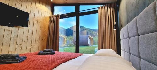 a bedroom with a bed and a large window at Рибничанка in Skhidnitsa