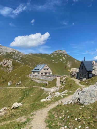 a house on the side of a mountain at 2-Zimmer Ferienwohnung an ruhiger Lage in Triesenberg