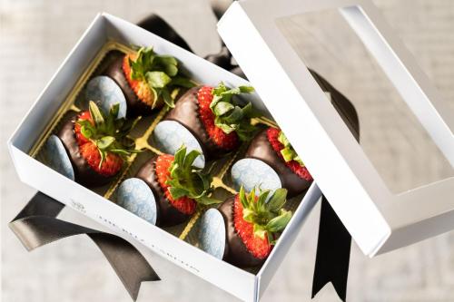 a box filled with chocolate dipped strawberries at The Ritz-Carlton, Dallas in Dallas