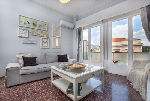 a living room with a couch and a table at Cosy Apartment With Acropolis View in Athens