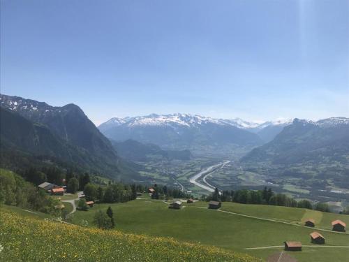 a view of a valley with snow capped mountains at 2-Zimmer Ferienwohnung an ruhiger Lage in Triesenberg