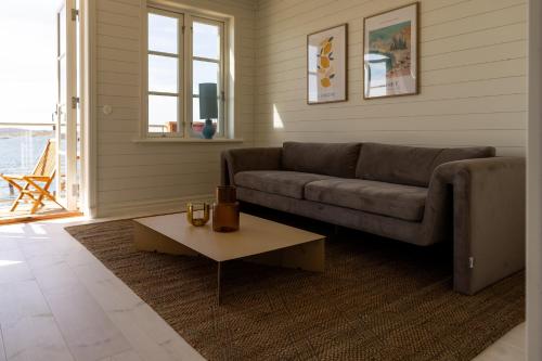 a living room with a couch and a coffee table at Hotel Strana in Hälleviksstrand