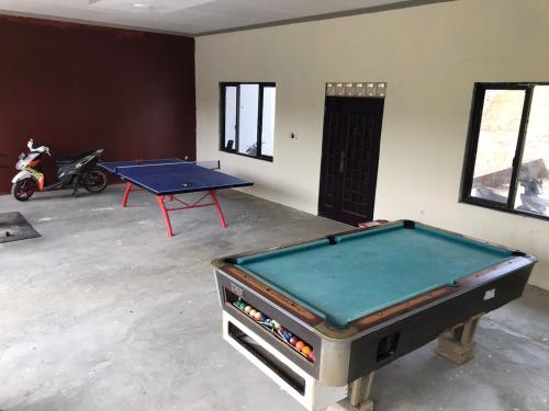 a room with a ping pong table in it at Vila Gunung Batu inces in Bogor