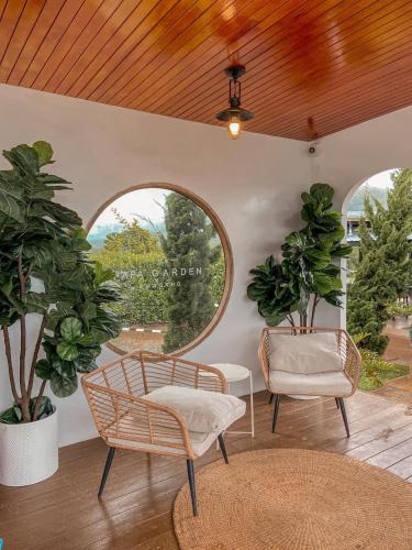 a living room with two chairs and a window at Papa Garden Khaokho in Khao Kho