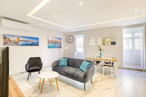 a living room with a couch and a table at Bluebell Apartment in Sliema in Sliema