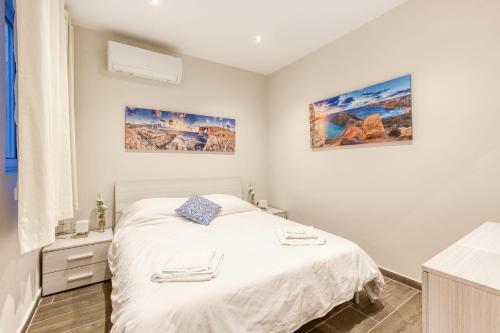 a small bedroom with a bed and a window at Bluebell Apartment in Sliema in Sliema