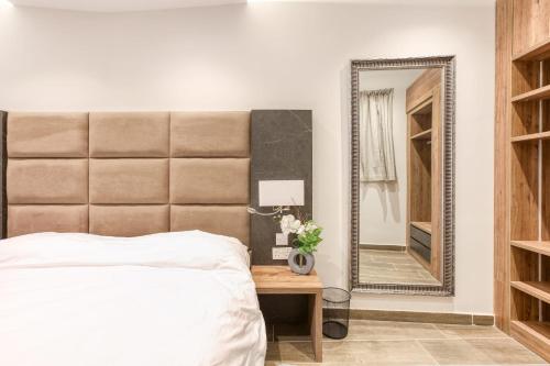 a bedroom with a bed and a mirror at Bluebell Apartment in Sliema in Sliema