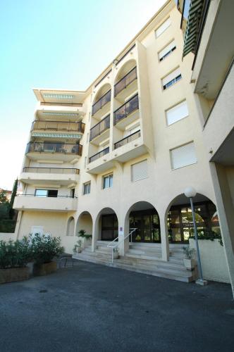 a large building with stairs in front of it at la palme d or in Saint-Raphaël