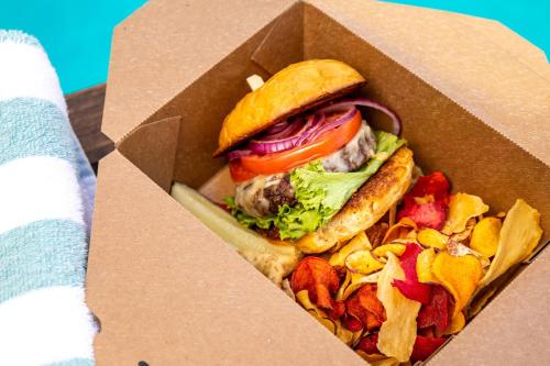 a sandwich in a box with chips and vegetables at The Westin Austin at The Domain in Austin
