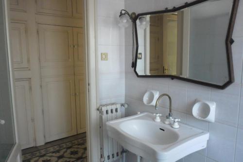 a bathroom with a white sink and a mirror at B&B Valle Allegra in Gravina di Catania