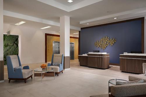 a lobby with a waiting room with chairs and a table at Courtyard by Marriott San Diego Mission Valley/Hotel Circle in San Diego