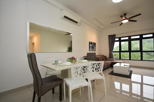 a kitchen and living room with a table and chairs at Meridin Medini Suite by Nest Home【LEGOLAND】 in Nusajaya
