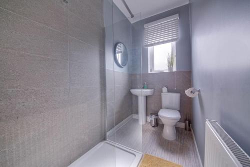 a bathroom with a toilet and a sink at Liquorice Lodge- 2 bed & parking in Castleford