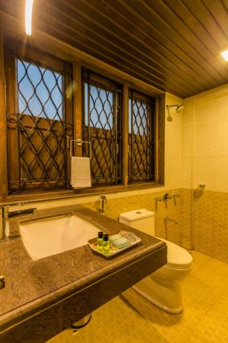 a bathroom with a bath tub and a toilet at matheran Green field Resorts in Matheran