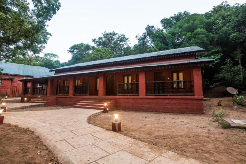 a red brick building with lights in front of it at Greenfield Resort, Matheran in Matheran
