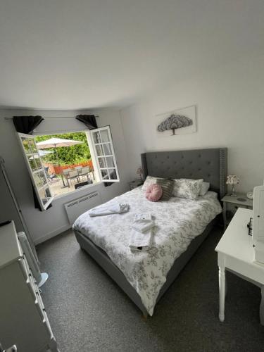 a small bedroom with a bed and a window at Vue du Château d'Excideuil en chambres in Excideuil