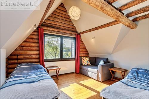 a room with two beds and a couch at Chalet 2 chambres "The Escape Chalet" by FineNest in Esneux