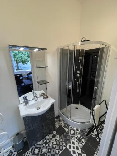 a bathroom with a shower and a sink and a mirror at Vue du Château d'Excideuil en chambres in Excideuil
