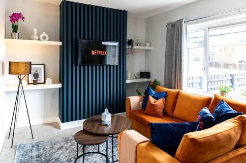 a living room with a couch and a table at Glasswing Stays The Collier's Rest in Barnsley