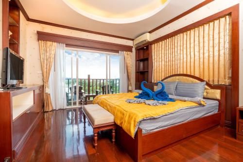 a bedroom with a bed with a blue ribbon on it at Orchid Pool Villa Phuket - SHA Extra Plus in Phuket Town