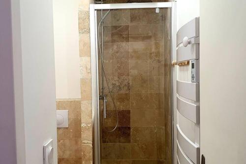 a shower with a glass door in a bathroom at la Perle Rare - Centre-Ville in Sète