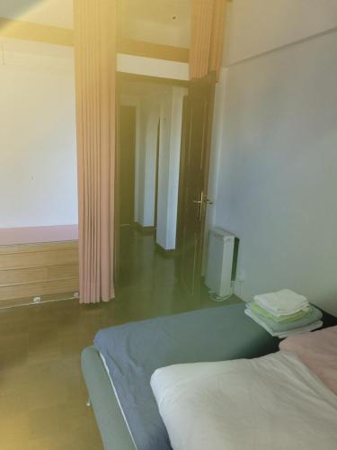 a bedroom with a bed and a tv in it at Comfy room near Metro and Airport in Lisbon