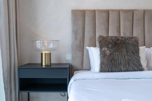 a bedroom with a bed and a lamp on a night stand at Stylish 2Bedroom w infinity pool on the 64th floor in Dubai