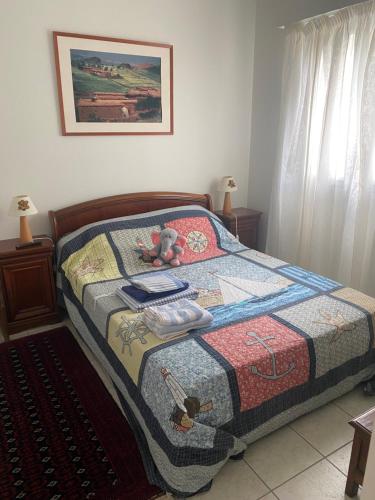 a bedroom with a bed with a quilt on it at Appartement 3 pièces de 52 m2 face au port du Crouesty avec terrasse de 18 m2 in Arzon
