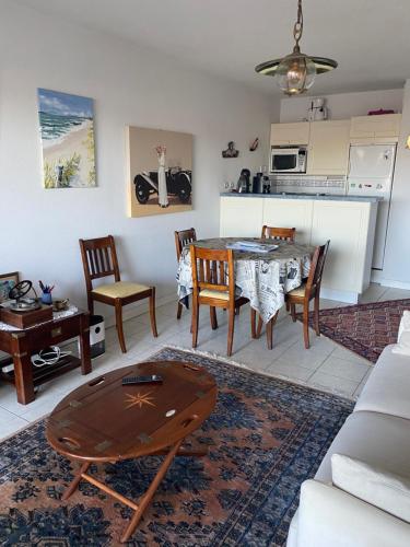 une cuisine et un salon avec une table et des chaises dans l'établissement Appartement 3 pièces de 52 m2 face au port du Crouesty avec terrasse de 18 m2 parking privé et wifi gratuit, à Arzon