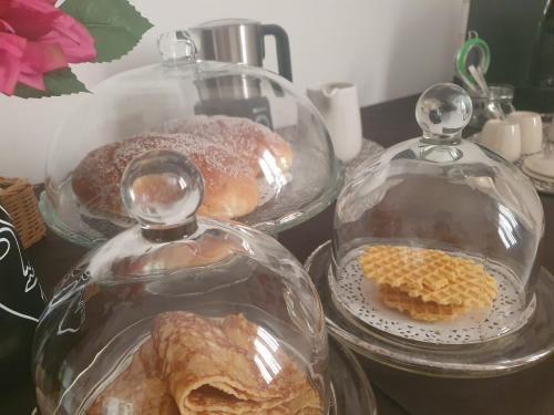 two glass domes with pastries in them on a table at La casa dei nonni in San Salvo