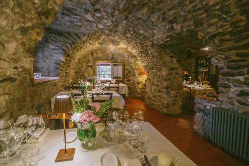 a room with a table with glasses and flowers on it at Agriturismo Ferdy in Lenna