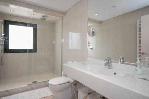 a bathroom with a sink and a toilet and a shower at CasaLeo HARRY - Roses / Costa Brava in Roses