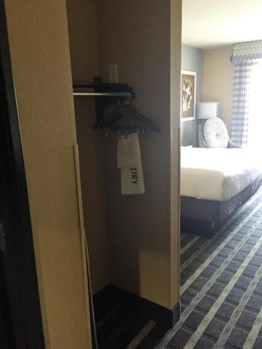 a room with a bedroom with a bed and a door at Holiday Inn Express & Suites Perry-National Fairground Area by IHG in Perry