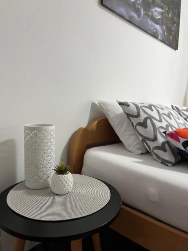 a table with a vase on it next to a couch at Rooms Horvat in Krapina