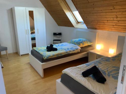 a bedroom with two beds and a mirror at KRIO Nicola Rothfuchs Ferienwohnung 2 in Idar-Oberstein