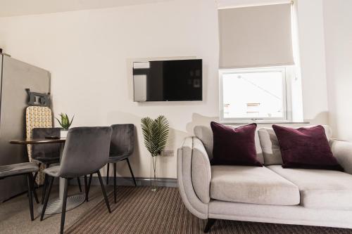 a living room with a couch and a table at Villette - 3 bdrm flat sleeps 5 great place for contractors in Sunderland
